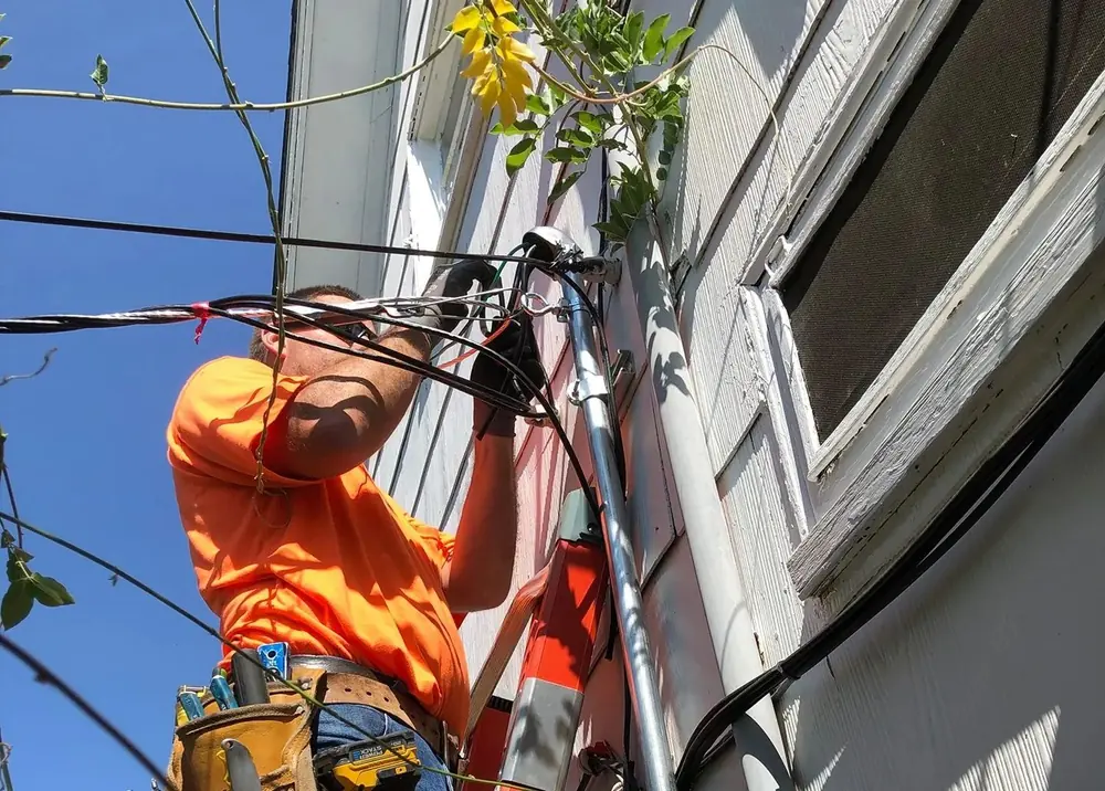 Electrician tracing and repairing residential wiring
